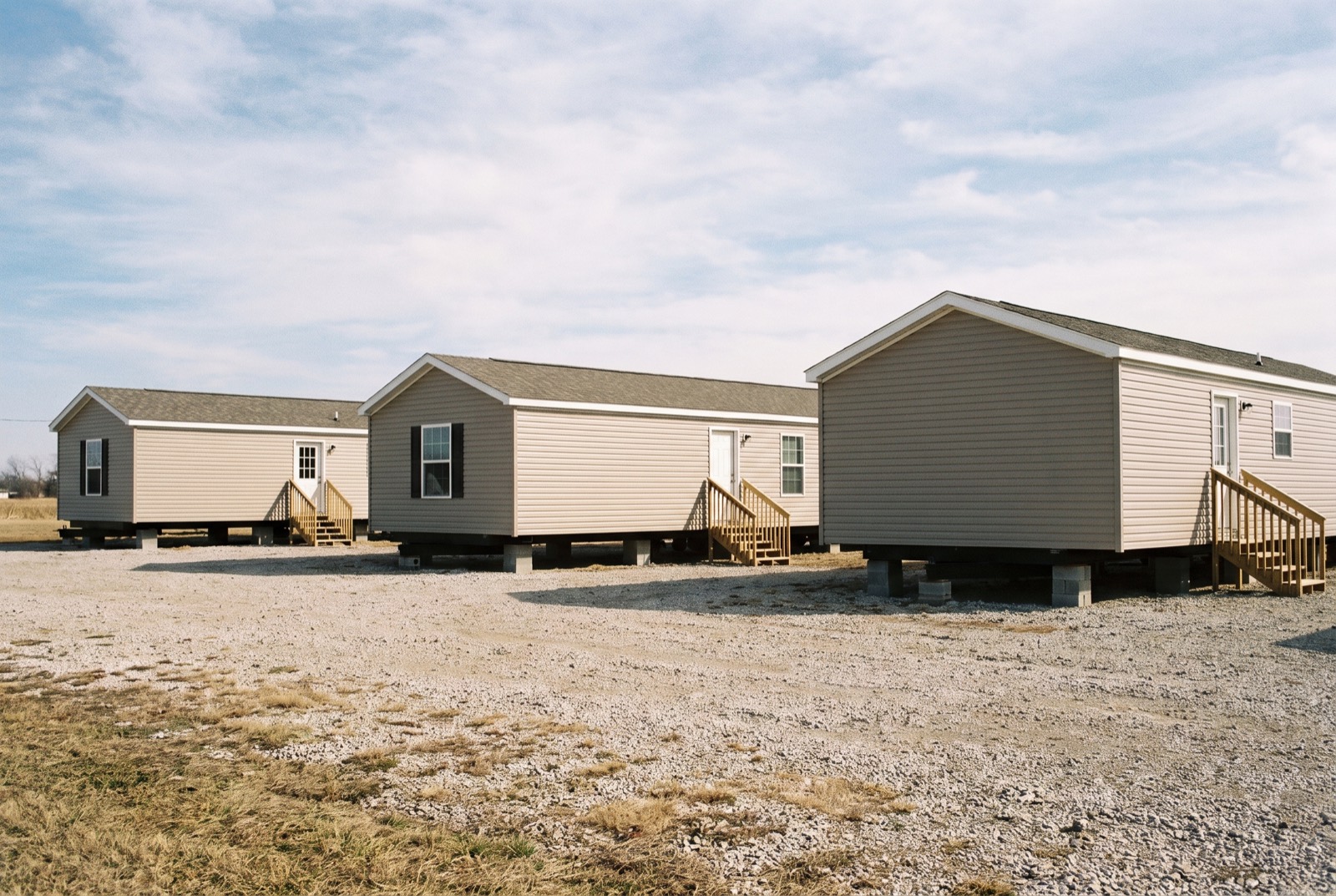 New manufactured homes on display on a dealer's gravel lot